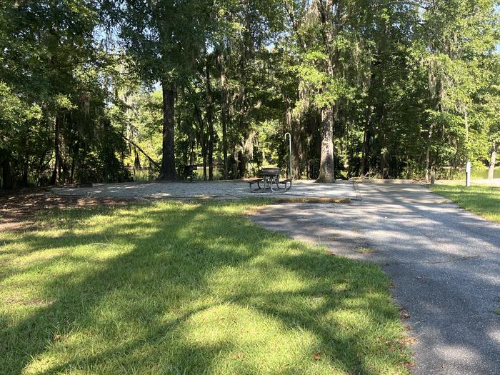 A photo of Site 82 of Loop CLOO at BLUFF CREEK with Picnic Table, Electricity Hookup, Sewer Hookup, Fire Pit, Shade, Food Storage, Tent Pad, Full Hookup, Waterfront, Lantern Pole, Water Hookup