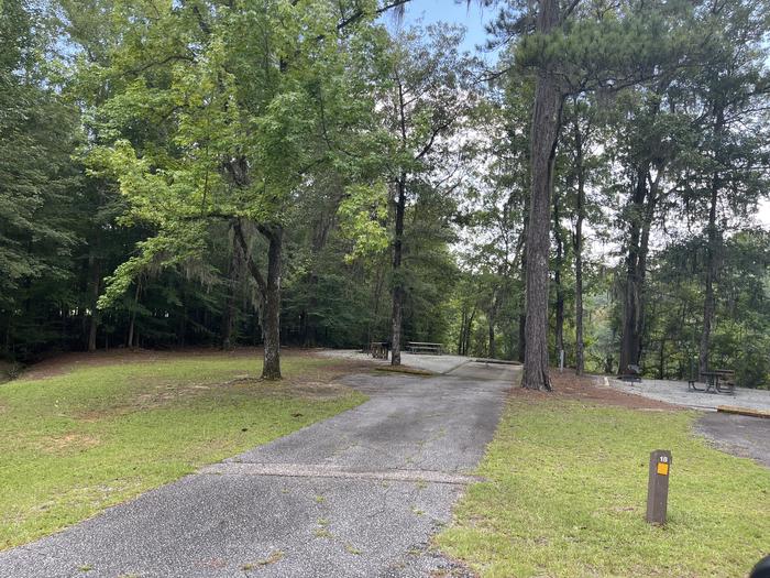 A photo of Site 18 of Loop MRUN at BLUFF CREEK with Picnic Table, Electricity Hookup, Sewer Hookup, Fire Pit, Shade, Tent Pad, Full Hookup, Waterfront, Lantern Pole, Water Hookup