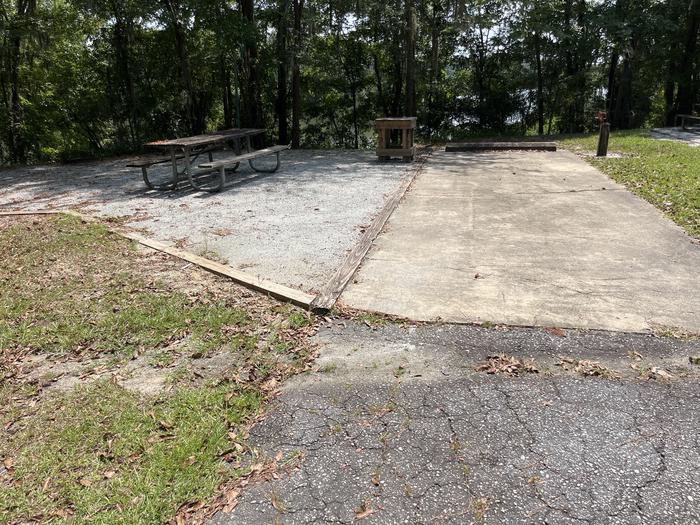 A photo of Site 51 of Loop RFOR at BLUFF CREEK with Picnic Table, Electricity Hookup, Fire Pit, Shade, Waterfront, Lantern Pole