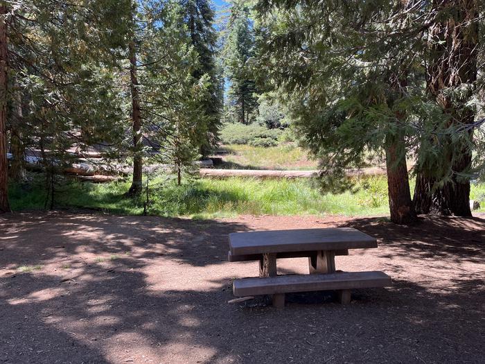 Picnic table near a grassy meadowA