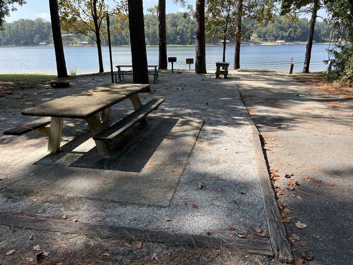 A photo of Site 062 of Loop CVIE at WHITE OAK (CREEK) CAMPGROUND with Picnic Table, Electricity Hookup, Fire Pit, Shade, Waterfront, Lantern Pole