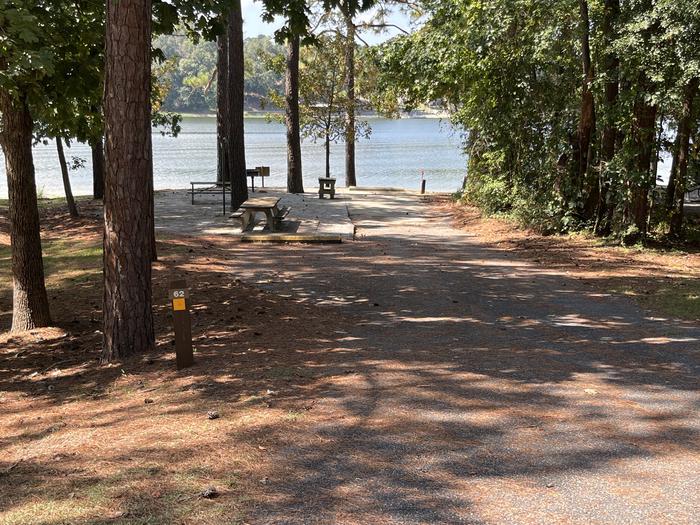 A photo of Site 062 of Loop CVIE at WHITE OAK (CREEK) CAMPGROUND with Picnic Table, Electricity Hookup, Fire Pit, Shade, Waterfront, Lantern Pole, Water Hookup