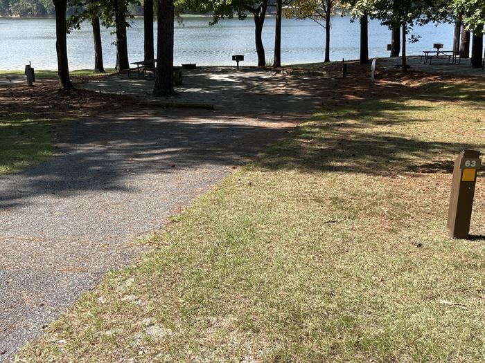A photo of Site 063 of Loop CVIE at WHITE OAK (CREEK) CAMPGROUND with Picnic Table, Electricity Hookup, Fire Pit, Shade, Waterfront, Lantern Pole, Water Hookup
