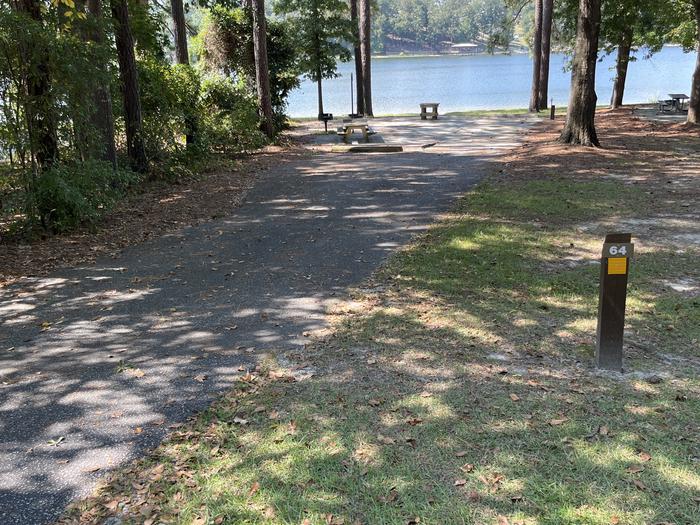 A photo of Site 064 of Loop CVIE at WHITE OAK (CREEK) CAMPGROUND with Picnic Table, Electricity Hookup, Fire Pit, Shade, Waterfront, Lantern Pole, Water Hookup