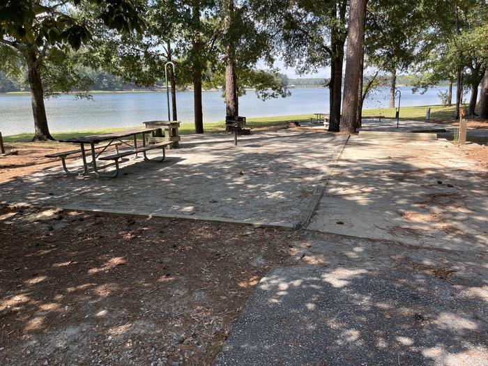 A photo of Site 068 of Loop CVIE at WHITE OAK (CREEK) CAMPGROUND with Picnic Table, Electricity Hookup, Fire Pit, Shade, Waterfront, Lantern Pole, Water Hookup