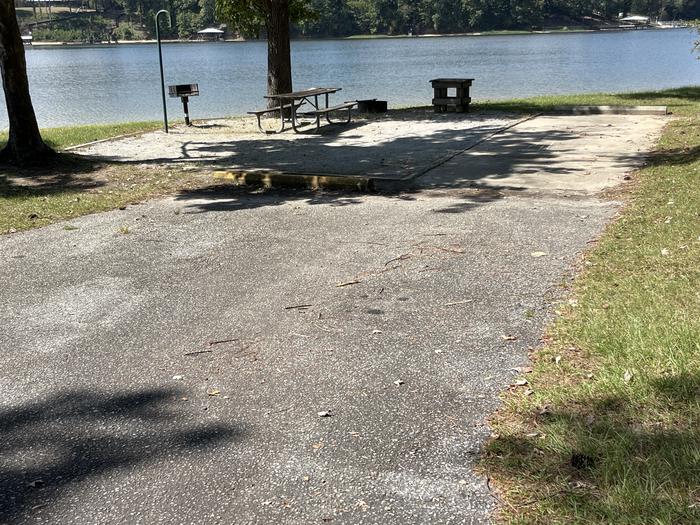 A photo of Site 077 of Loop CVIE at WHITE OAK (CREEK) CAMPGROUND with Picnic Table, Electricity Hookup, Fire Pit, Shade, Waterfront, Lantern Pole, Water Hookup