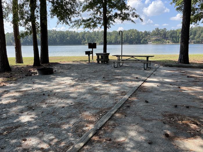A photo of Site 082 of Loop CVIE at WHITE OAK (CREEK) CAMPGROUND with Picnic Table, Electricity Hookup, Fire Pit, Shade, Waterfront, Lantern Pole, Water Hookup