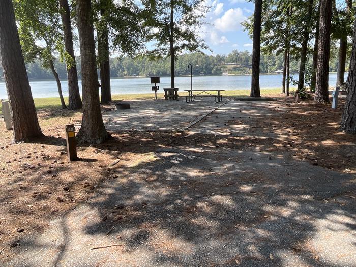 A photo of Site 082 of Loop CVIE at WHITE OAK (CREEK) CAMPGROUND with Picnic Table, Electricity Hookup, Fire Pit, Shade, Waterfront, Lantern Pole, Water Hookup