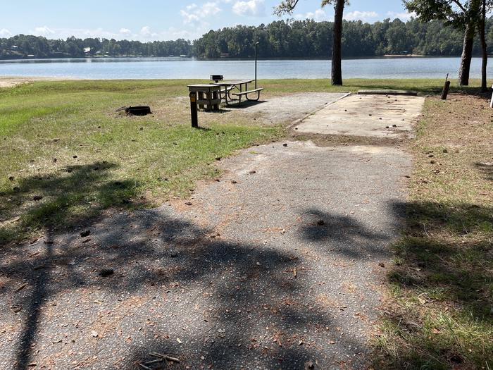 A photo of Site 083 of Loop CVIE at WHITE OAK (CREEK) CAMPGROUND with Picnic Table, Electricity Hookup, Fire Pit, Waterfront, Lantern Pole, Water Hookup