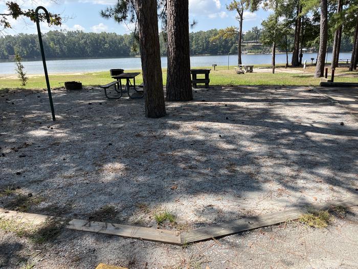 A photo of Site 086 of Loop CVIE at WHITE OAK (CREEK) CAMPGROUND with Picnic Table, Electricity Hookup, Fire Pit, Shade, Waterfront, Lantern Pole
