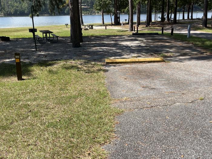 A photo of Site 086 of Loop CVIE at WHITE OAK (CREEK) CAMPGROUND with Picnic Table, Electricity Hookup, Fire Pit, Shade, Waterfront, Lantern Pole, Water Hookup