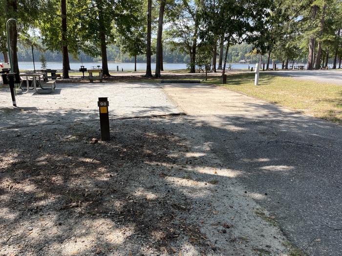 A photo of Site 098 of Loop CVIE at WHITE OAK (CREEK) CAMPGROUND with Picnic Table, Electricity Hookup, Fire Pit, Shade, Lantern Pole, Water Hookup