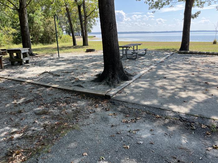 A photo of Site 095 of Loop CVIE at WHITE OAK (CREEK) CAMPGROUND with Picnic Table, Electricity Hookup, Fire Pit, Shade, Waterfront, Lantern Pole, Water Hookup