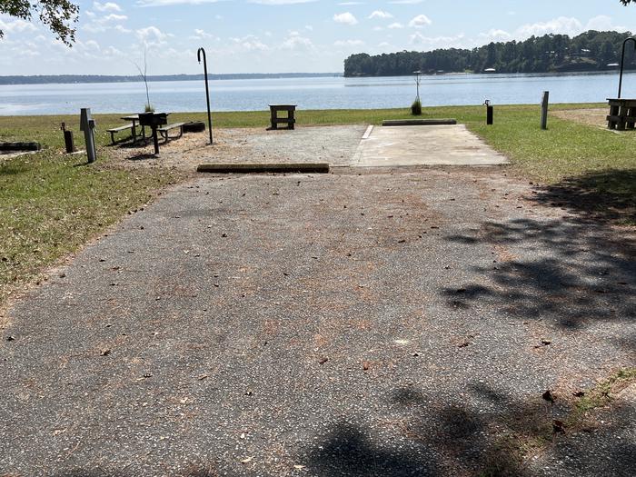 A photo of Site 094 of Loop CVIE at WHITE OAK (CREEK) CAMPGROUND with Picnic Table, Electricity Hookup, Fire Pit, Waterfront, Lantern Pole, Water Hookup