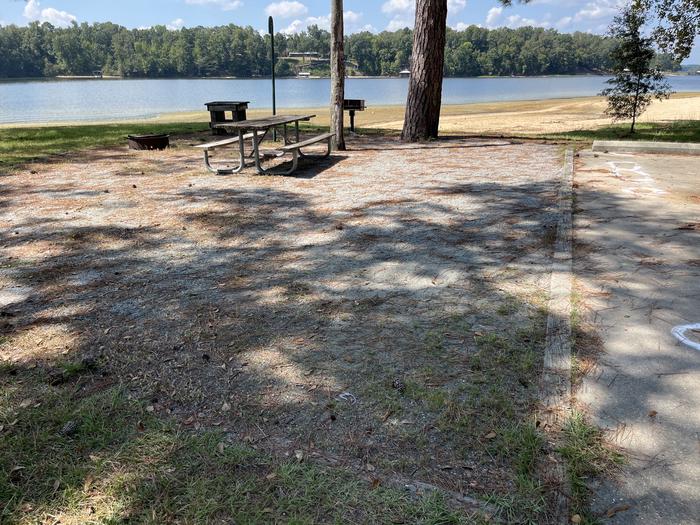 A photo of Site 090 of Loop CVIE at WHITE OAK (CREEK) CAMPGROUND with Picnic Table, Electricity Hookup, Fire Pit, Waterfront, Lantern Pole, Water Hookup