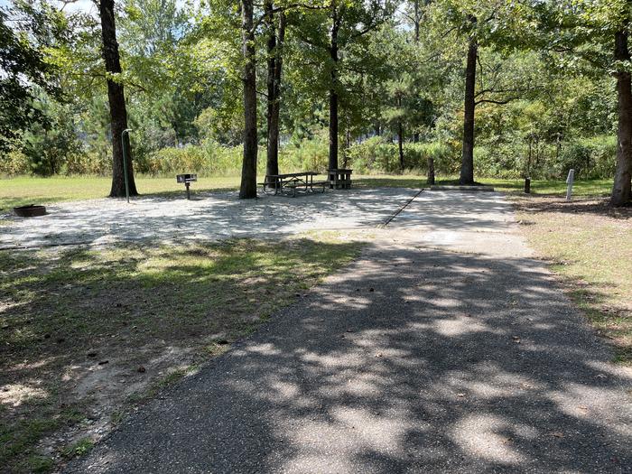 A photo of Site 104 of Loop RCHA at WHITE OAK (CREEK) CAMPGROUND with Picnic Table, Electricity Hookup, Fire Pit, Shade, Waterfront, Lantern Pole, Water Hookup