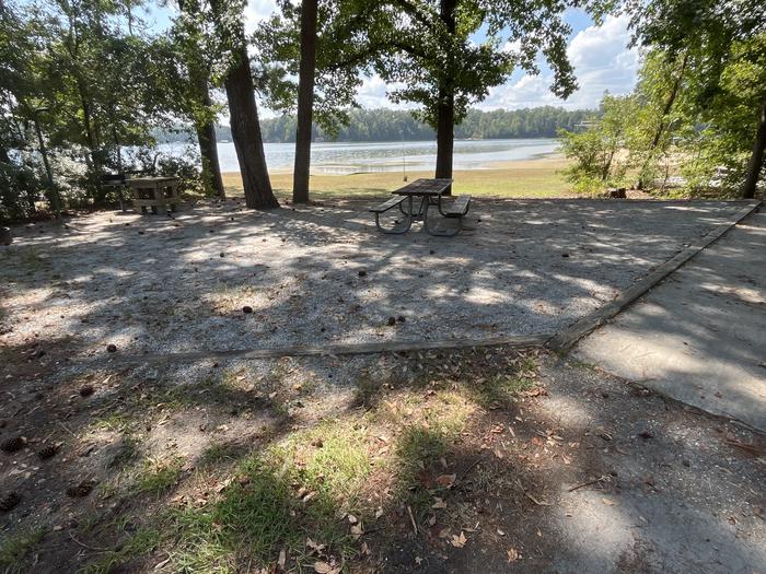 A photo of Site 107 of Loop RCHA at WHITE OAK (CREEK) CAMPGROUND with Picnic Table, Electricity Hookup, Fire Pit, Shade, Waterfront, Lantern Pole, Water Hookup