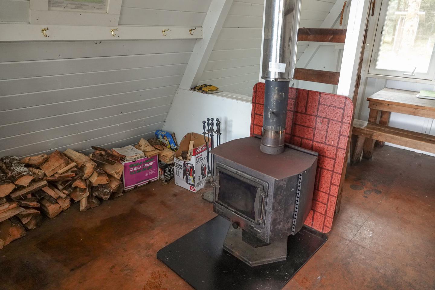 woodstove and woodpile inside the cabinCabin interior and woodstove