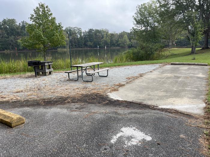 A photo of Site 65 of Loop PBLU at BLUFF CREEK with Picnic Table, Electricity Hookup, Fire Pit, Waterfront, Lantern Pole, Water Hookup