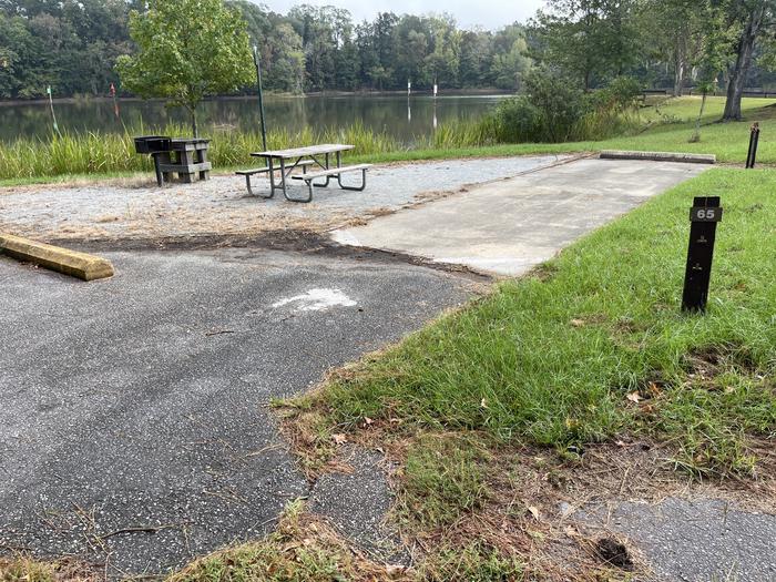 A photo of Site 65 of Loop PBLU at BLUFF CREEK with Picnic Table, Electricity Hookup, Fire Pit, Waterfront, Lantern Pole, Water Hookup