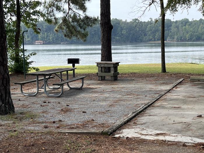 A photo of Site 109 of Loop RCHA at WHITE OAK (CREEK) CAMPGROUND with Picnic Table, Electricity Hookup, Fire Pit, Shade, Waterfront, Lantern Pole, Water Hookup
