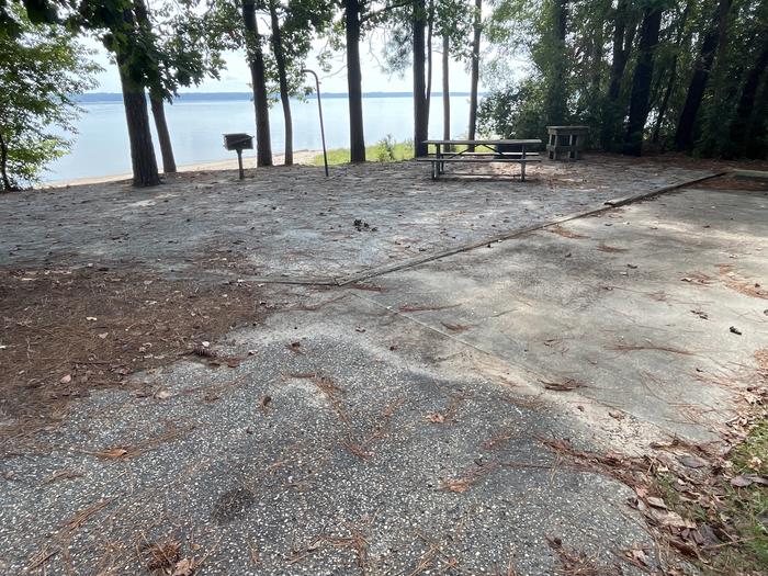A photo of Site 116 of Loop RCHA at WHITE OAK (CREEK) CAMPGROUND with Picnic Table, Electricity Hookup, Fire Pit, Shade, Waterfront, Lantern Pole, Water Hookup