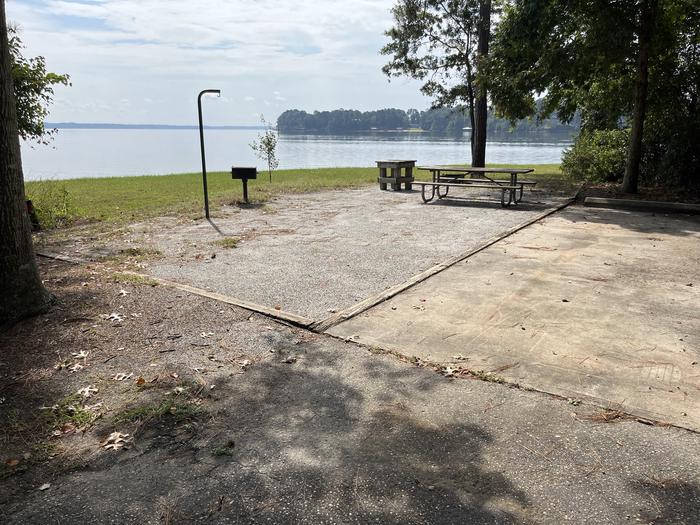 A photo of Site 114 of Loop RCHA at WHITE OAK (CREEK) CAMPGROUND with Picnic Table, Electricity Hookup, Fire Pit, Waterfront, Lantern Pole, Water Hookup