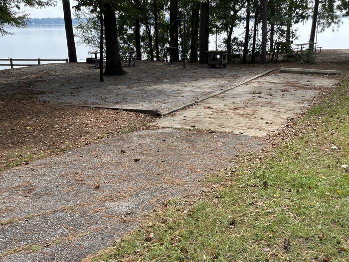A photo of Site 118 of Loop RCHA at WHITE OAK (CREEK) CAMPGROUND with Picnic Table, Electricity Hookup, Fire Pit, Shade, Waterfront, Lantern Pole, Water Hookup
