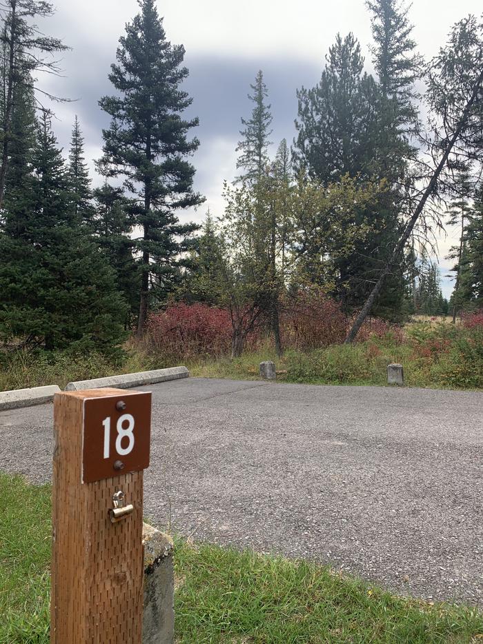 A photo of Site BLS18 in Loop 2 at Big Larch Campground with campsite marker, parking area. 