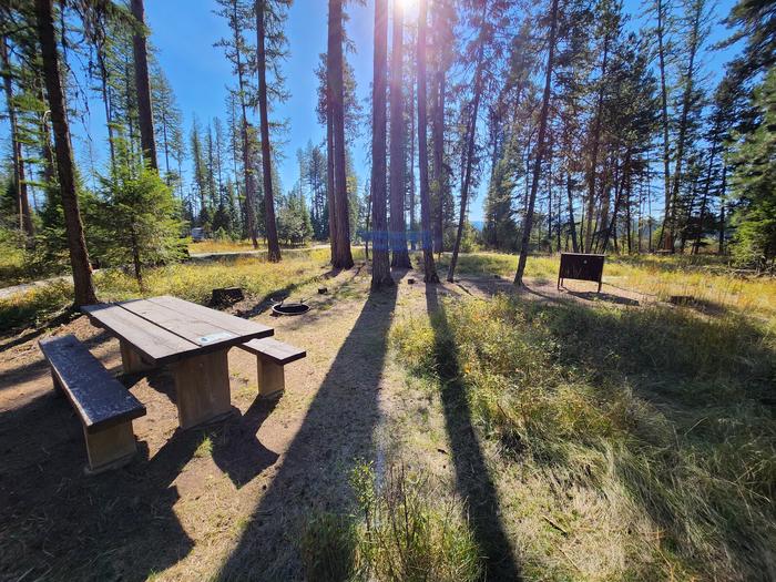 A photo of Big Larch Bike Site 1 (BLBS1) in Loop 1 at Big Larch Campground with a picnic table, campfire ring, and food storage locker.