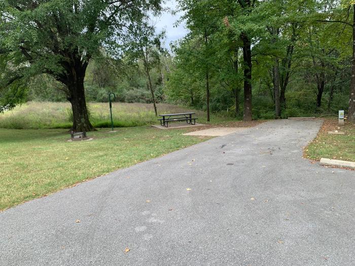 picnic table and fire pit located to the left of camp pad, electric, water, sewer, and extra parking to the right of pad. located near bathroom
