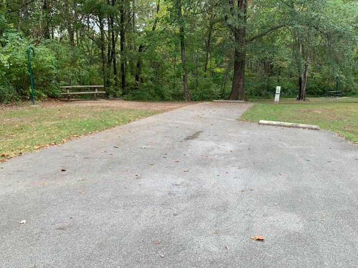 picnic table and fire pit located to the left of camp pad, electric and extra parking to the right of pad. located near bathroom