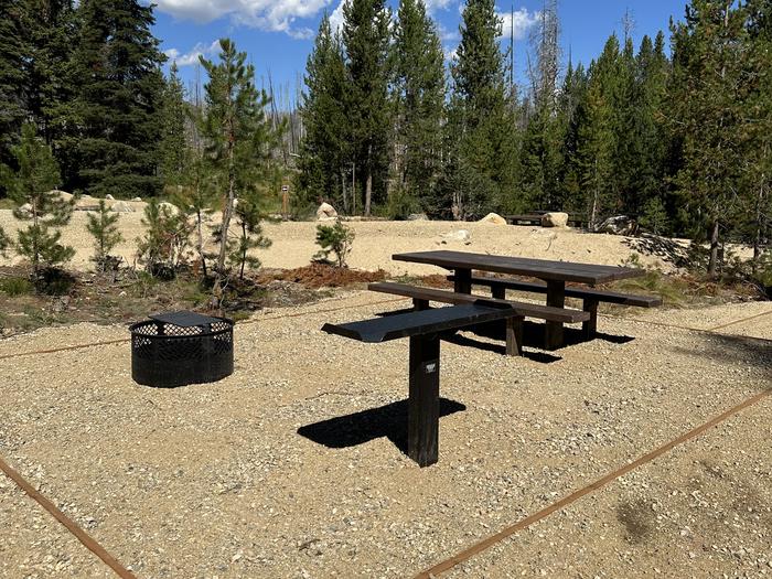 One picnic table, one utility table, one fireringSite 5 picnic area
