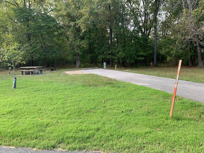 There is a picnic table located on the left side of the pad. Hook ups are rear right side of the parking pad. This site is located near a shower house and drinking fountain. 