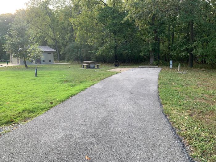 There is a picnic table located on the left side of the pad. Hook ups are rear right side of the parking pad. This site is located near a shower house and drinking fountain. 