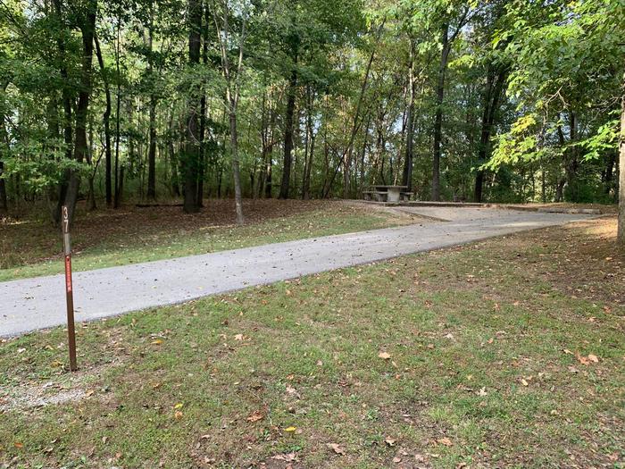 This site has a picnic table and fire pit on the left side of the paved pads. The hookups for this site are located to the right rear side of the paved parking pad. There is a walking/bike path near by and has an additional pad for camping supplies. This site has a picnic table and fire pit on the left side of the paved pads. The hookups for this site are located to the right rear side of the paved parking pad. There is a walking/bike path near by and has an additional pad for camping supplies. This site is near the waters edge.