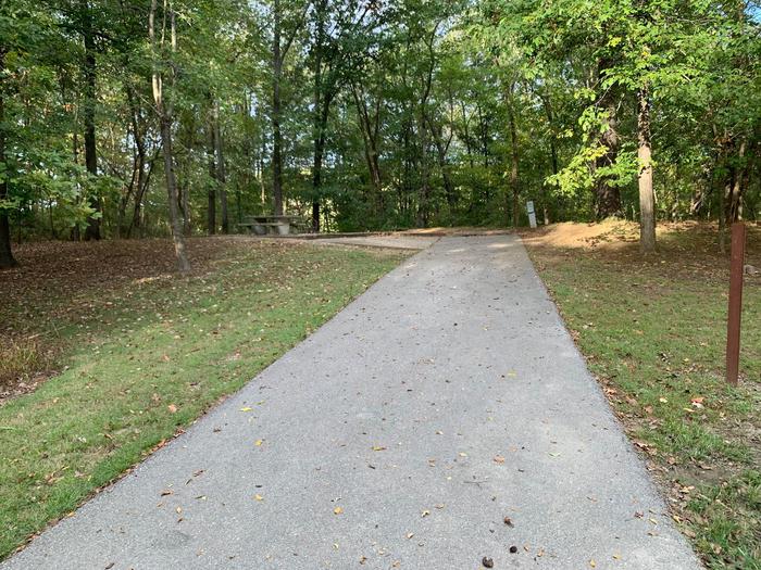 This site has a picnic table and fire pit on the left side of the paved pads. The hookups for this site are located to the right rear side of the paved parking pad. There is a walking/bike path near by and has an additional pad for camping supplies. This site has a picnic table and fire pit on the left side of the paved pads. The hookups for this site are located to the right rear side of the paved parking pad. There is a walking/bike path near by and has an additional pad for camping supplies.  This site is near the waters edge.