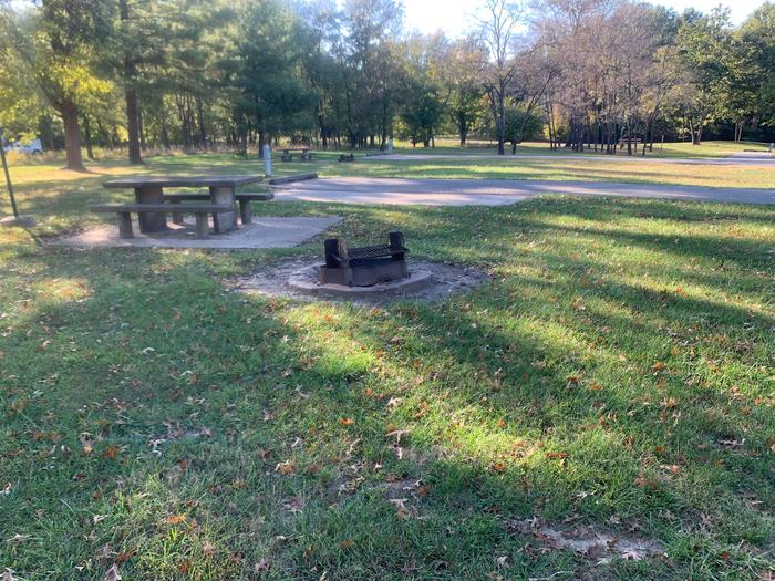 This site is located in the loop of the campground. The picnic table and fire pit are located to the left of the site. 
