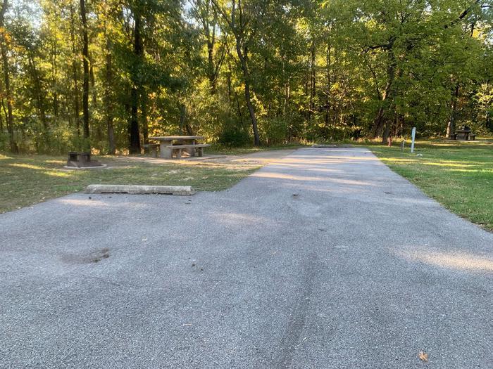 This is a full hookup site. Picnic table and fire pit are on the left side of the paved parking/camping pad. Hookups are on the right. This site is within walking distance to the comfort station. 
