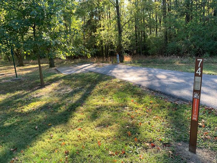This site is nestled in the trees providing plenty of shade. The picnic table and fire pit is located to the left of the paved parking/camping pad. Electricity hookup is on the right. This site is near the waters edge providing a great view. Electricity hookup is on the right. The picnic table and fire pit are on the left side of the paved parking/camping pad. 