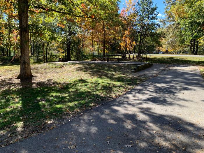This is a handicap accessible site. The picnic table and fire pit are located on a paved pad to the left side on the main camping pad. All hookups are located on the left side. 