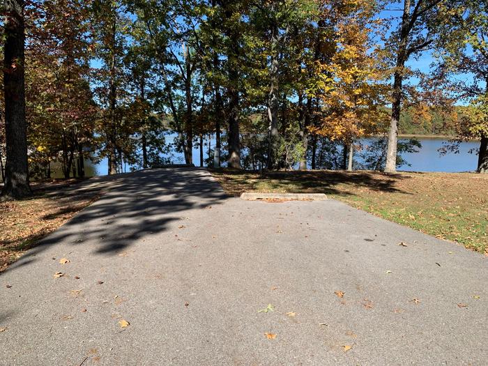 This site is located near the waters edge providing a great view of the lake. The picnic table is located on the left along with the fire pit. Electric hookup is on the right. 