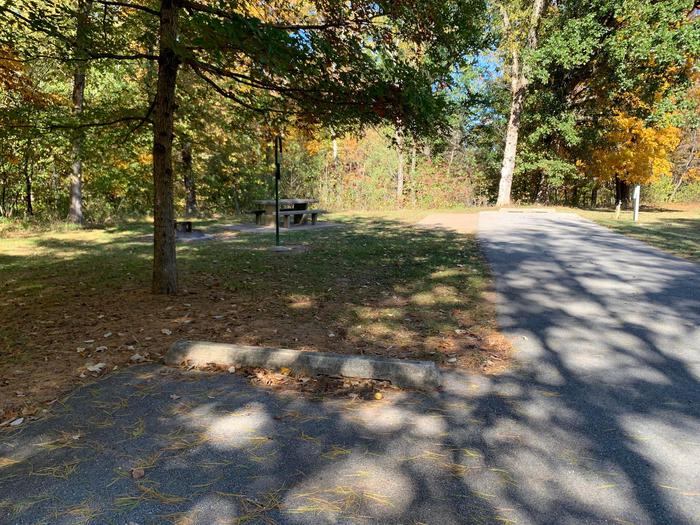 This is a full hookup site with all hookups located on the right. The picnic table and fire pit are located on the left side. This site is nestled in the trees providing shade for your site. It is also located near the comfort station and drinking fountain. 