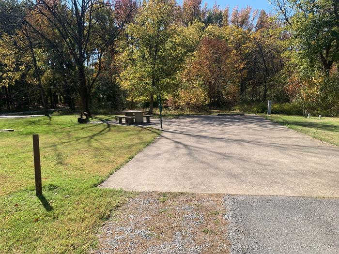 This is a full hookup site and is located next to a shower house. All hookups are on the right side of the paved parking/camping pad. Picnic table and fire pit are on the left side. This site has an extra large pad for extra space. This is a handicap accessible site.This is a full hookup site. Picnic table and fire pit are on the left side of the paved parking/camping pad. Hookups are on the right. This site is within walking distance to the comfort station. This is a handicap accessible site.