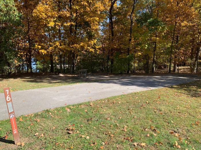 This site is near the waters edge providing a great view of the lake. The picnic table and fire pit are of the left side of the paved parking/camping pad. The electricity hookup is on the right side. 