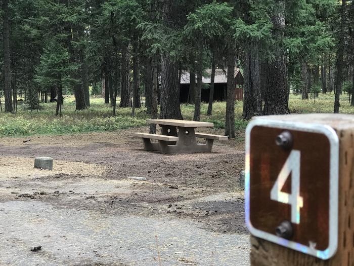 A photo of Site SLS4 in Loop 1 at Seeley Lake Lolo Campground (MT) with campsite marker, picnic table. A photo of Site SLS4 in Loop 1 at Seeley Lake Lolo Campground (MT) with campsite marker, picnic table.