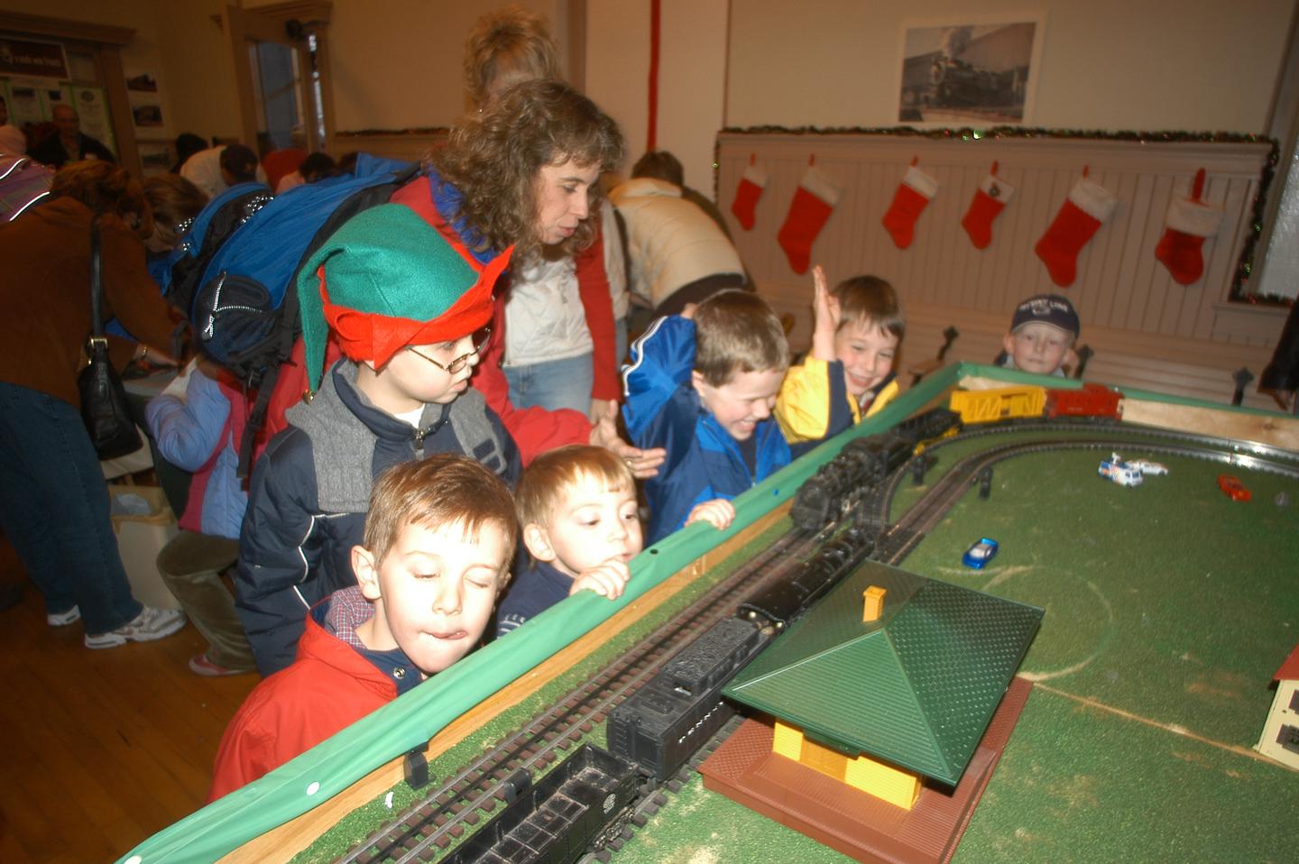 6 young visitors and 1 adult observe a model trainVisitors to Moscow Station for the "Holiday Express" can enjoy model train displays in addition to holiday activities.
