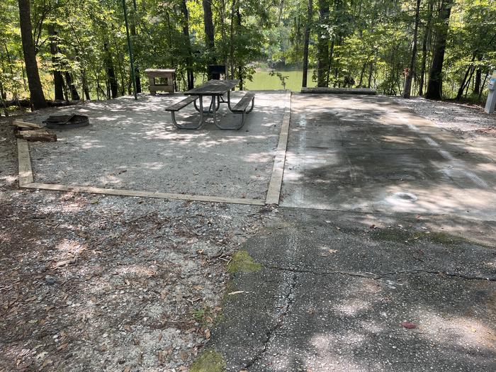 A photo of Site 26 of Loop RFOR at BLUFF CREEK with Electricity Hookup, Sewer Hookup, Fire Pit, Shade, Waterfront, Lantern Pole, Water Hookup