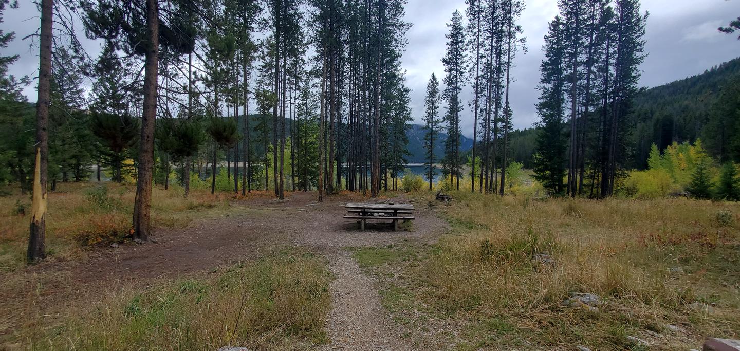 Campsite with picnic tables and view of reservoirCampsite