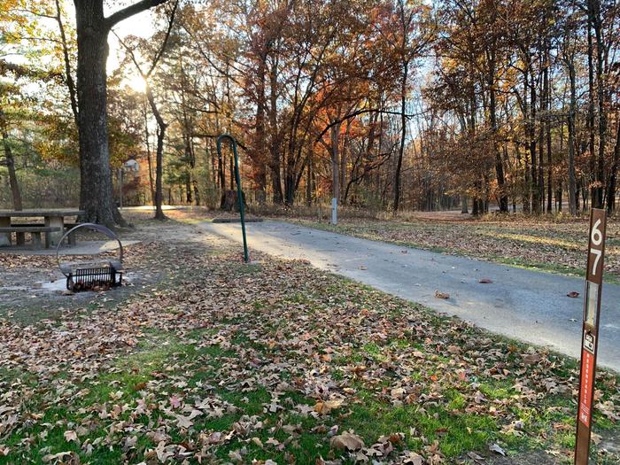 This is a handicap accessible site with full hookups. This site has a picnic table and a fire pit located on the left side of the paved parking/camping pad.  It is near a playground and drinking fountain. 